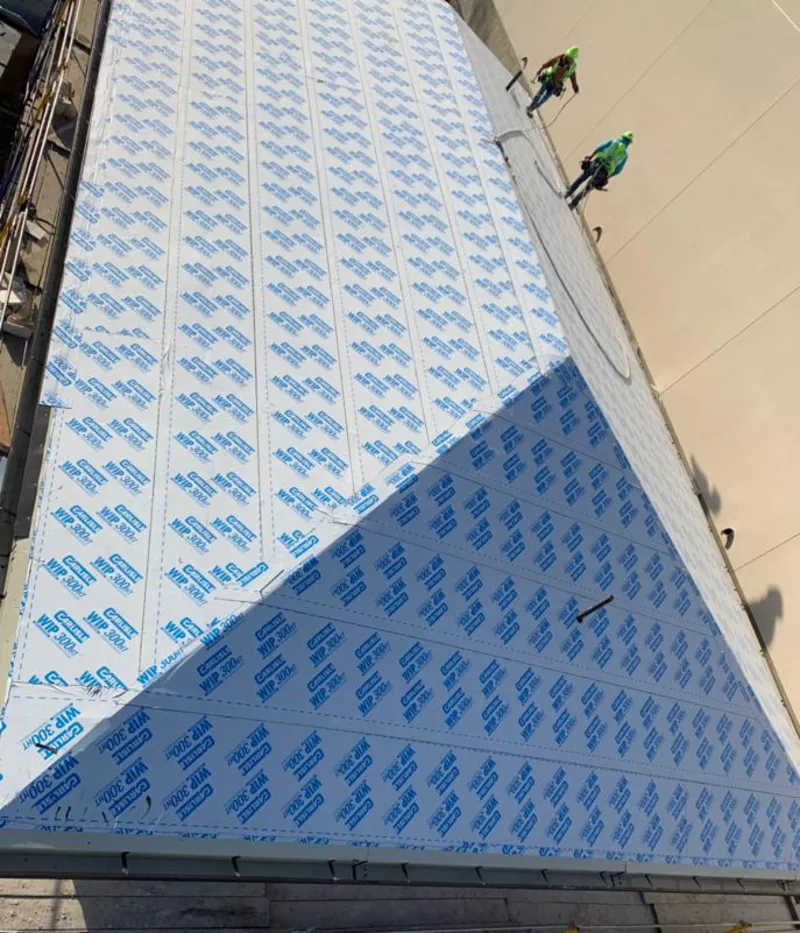 Professional roofers installing underlayment on a metal roof in Macedonia